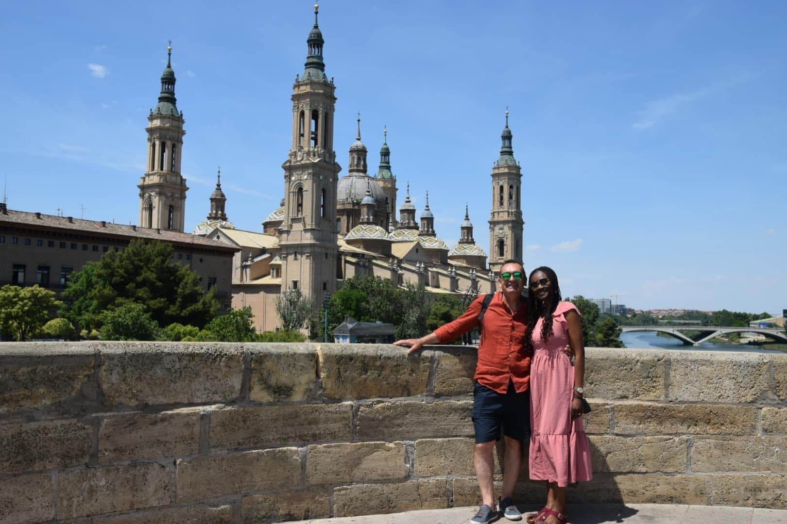 Posing for a shot on a bridge in order to get the best shot of the Basilica of Our Lady of Pillar, Zaragoza, Spain