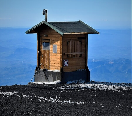 A small cabin house on the volcanic mount Etna, a low-budget winter destination
