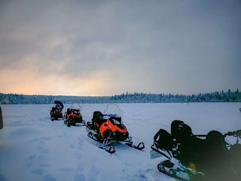 A line of snowmobiles in an icy landscape