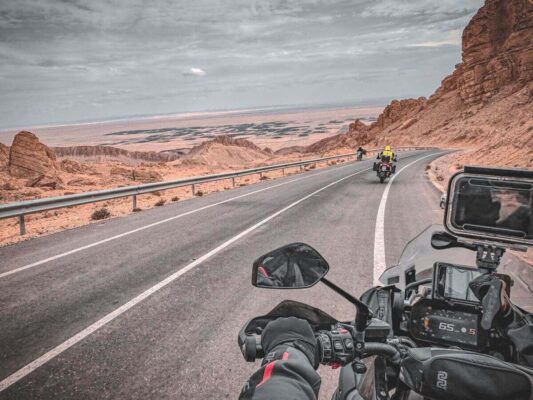 A motorcyclist riding on a winding road around a mountainous region in Tunisia