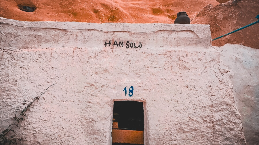 Entrance to a cave room with the name "HAN SOLO" written above the door