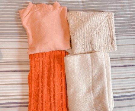 Warm wool clothes, folded and laid out