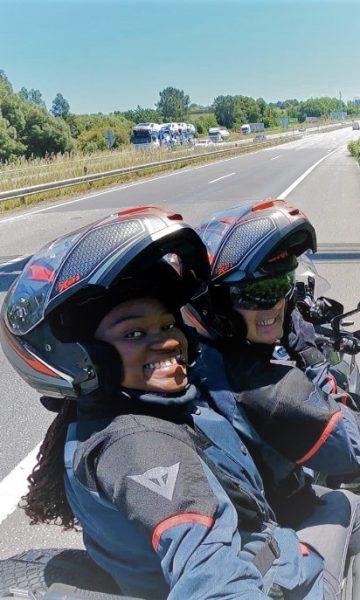 A couple on a motorcycle travelling and crossing the border