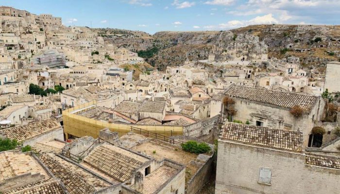 A landscape of a town made from cave houses with a valley dividing the town